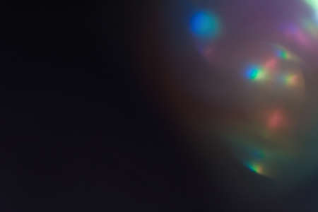 blurred defocused bright light. lens flare. shiny spots. dark backgroundの写真素材
