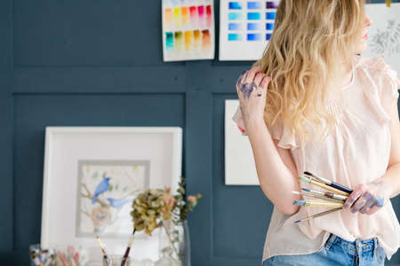creative leisure. painting hobby. artful personality. painter holding brushes. hands covered with ink dyes colorsの写真素材