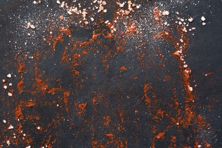 food preparing and cooking. spices mix on dark background. chunks of salt and red pepper or paprika condiment.の写真素材