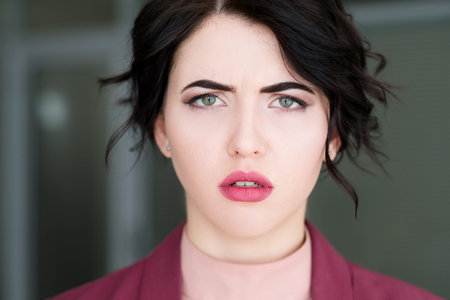 emotion face. sad worried upset concerned unhappy woman. young beautiful brunette girl portraitの写真素材