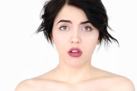 emotion face. speechless dumbstruck taken aback dazed woman young beautiful brunette girl portrait on white background.の写真素材