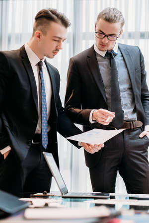 business results discussion. report documents review. professional coworkers read financial papers with diagrams and graphs. corporate managers focused on statistics dataの写真素材