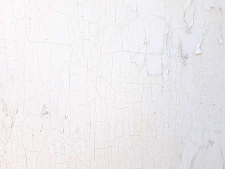 shabby old flaky plaster wall background. white damaged crackled paint. weathered worn out surface. copyspace conceptの写真素材