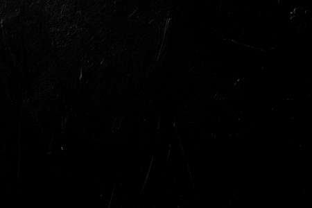 black scratched background. distressed dark stucco plaster texture decor. free space conceptの写真素材