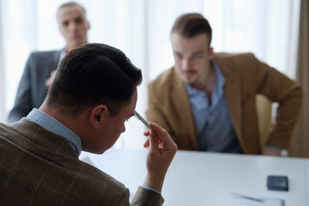pensive business men sitting at a board meeting thinking over some problem or situation. thought processの写真素材
