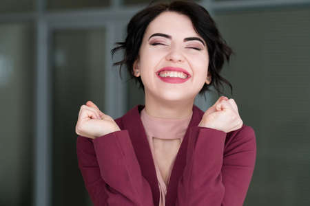 emotion face. smiling woman pleased with herself. self-satisfied young beautiful brunette girl. portraitの写真素材