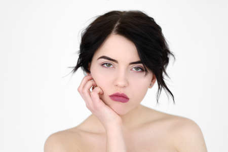 emotion face. bored fed up unimpressed apathetic woman. young beautiful brunette girl portrait on white background.の写真素材