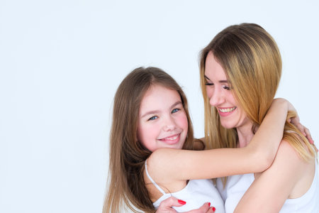 mom and daughter hugging. emotion expression and happy feelings. joyful childhood and parenting momentsの写真素材