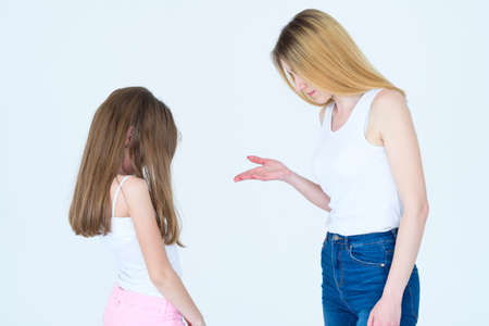 mom scolding little daughter. mother nagging or telling off her kid. family relationship parenting and child raising.の写真素材