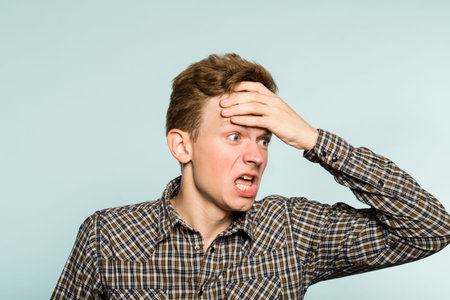 Man boiling with anger. infuriated and enraged reaction. portrait of a young guy on light...