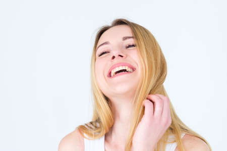 emotion face. very happy joyful thrilled to bits woman with beaming smile. young beautiful blond girl portrait on white background.の写真素材