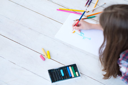 kid creativity and art. girl drawing a flower. child leisure hobby and self expression.の写真素材