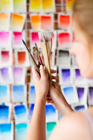 art painting inspiration creativity concept. artist professional brushes set in woman hands. color...