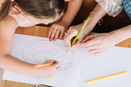 family leisure. creative and artful mother and daughter drawing together. loving relationship and...