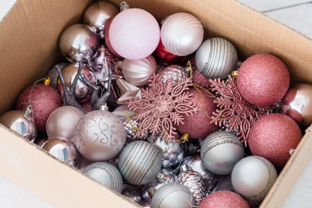 assortment of christmas decorative balls in a box. mix of silver and rose gold baubles snowflakes...