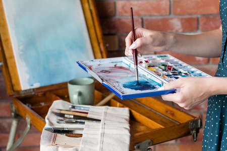 art painting hobby. creative leisure. artist mixing watercolors preparing to draw picture. talent inspiration creation and self expression concept.の写真素材