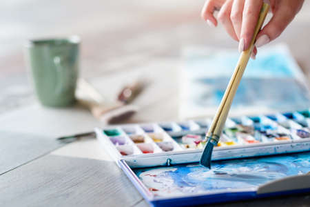 art painting hobby. creative leisure. artist mixing watercolors preparing to draw picture. talent inspiration creation and self expression concept.の写真素材