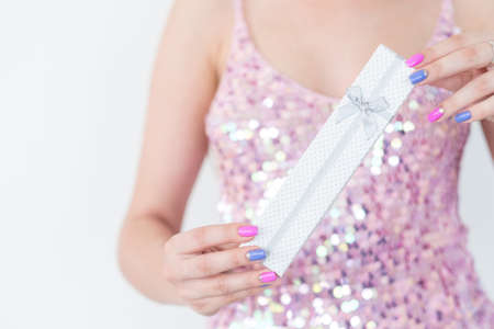 special female jewelry gift. luxury presents and reward concept. woman holding an elegant box with a bow.の写真素材