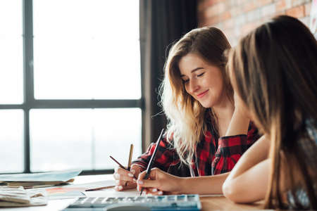 art school classes. painting courses. student and teacher drawing together. technique mastering and skills improvement.の写真素材