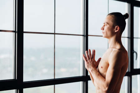 yoga instructor. fitness trainer. sport and athletic lifestyle. concentrated serene fit toned and muscular male teacher.の写真素材