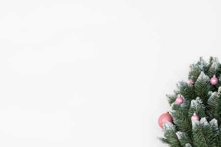 christmas holiday festive background. decorated fir tree in the right corner on the white backdrop. free space conceptの写真素材