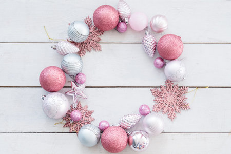 new year festive background. wreath made of decorative toys balls and snowflakes. selection of holiday embellishments. empty negative space concept.の写真素材