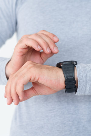 punctuality self discipline and time management. man looking at watch on his hand checking if he is...