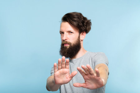 no thanks. rejection refusal and denial. young casual hipster man putting hands forward as if...