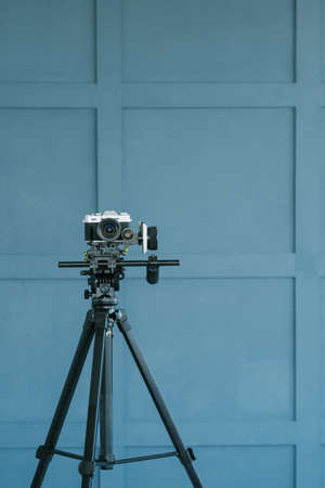 fashion blogging and video streaming. style beauty and trends in social media concept. camera on tripod focusing on clothes on the rack.の写真素材