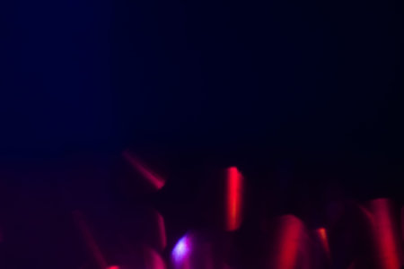 abstract lens flare on dark blue background. pink and purple defocused lights. glowing blurred color...