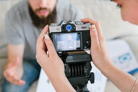 video content creation process. woman holding camera and shooting footage for blog or online...