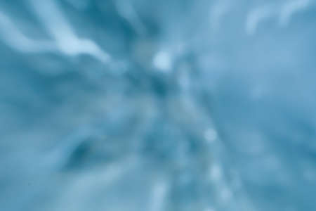 blue glowing defocused blurred christmas wallpaper decor. abstract lens flare background.の写真素材