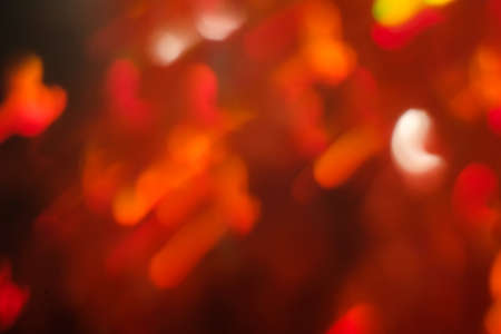 abstract lens flare on black background. red defocused lights. glowing blurred color burst. festive new year backdrop.の写真素材