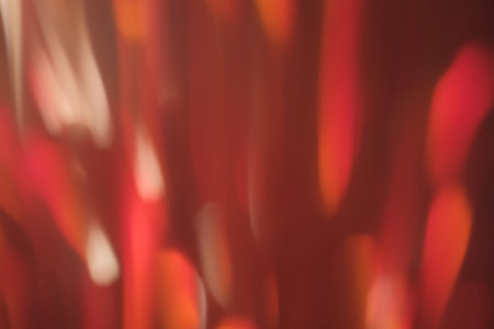 blurred lens flare glow. abstract defocused red light stripes. christmas festive background decoration.の写真素材