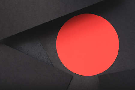paper layers. contrast of black sheets and red circle. minimalistic abstract background with copyspace.の写真素材