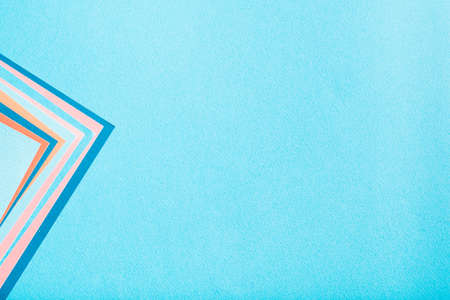 construction paper texture background. blue backdrop with colorful geometric accent sheets. copyspace concept.の写真素材