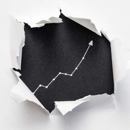 exponential diagram on black background showing through ripped white paper. trend success increase concept.の写真素材