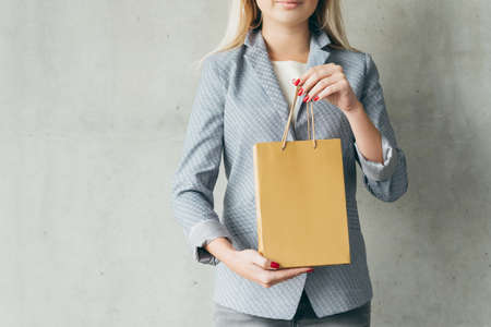 shopping hobby concept. brown paper bag in woman hands.の写真素材