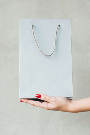 shopping bag on woman hand. consumerism and money spending lifestyle.の写真素材
