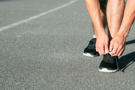 runner tying shoelaces. track and field athletics. sports and active lifestyle.