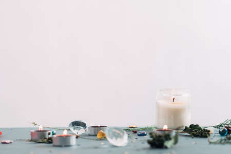 festive holiday background with copyspace. candles and twigs seasonal decor on the surface. christmas spirit and new year atmosphere.の写真素材