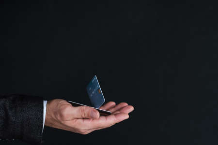 online payment. money transaction and orders. man holding credit card in handの写真素材