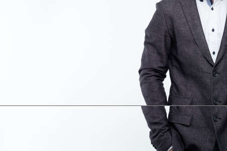 man in suit jacket. powerful pose with hands in pockets. business trainer success and confidence.の写真素材