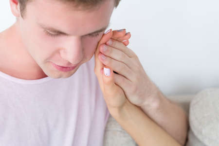 man holding womans hand. love bond support and nonverbal communication.の写真素材