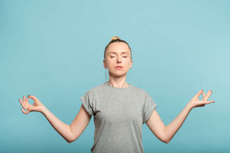 woman holding her hands in chin mudra. emotional equilibrium and balance.の写真素材