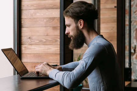 man working on laptop in cafe. freelance or remote job.