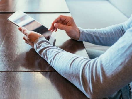 technology innovation and development. man typing on tablet using sensor touch screen to enter data.の写真素材