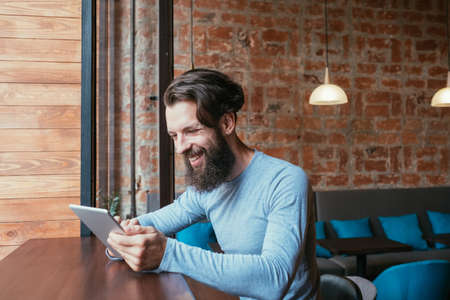 online games and playing apps. man using tablet. technology and mobile gadgets addiction.の写真素材