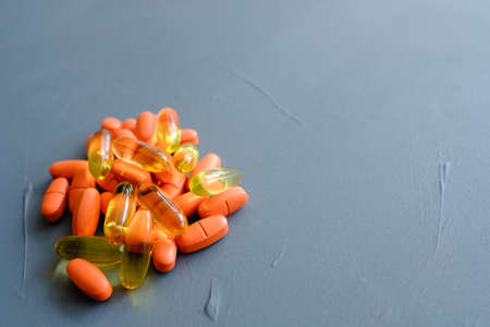 pills and capsules mix. illness sickness and medicament drugs on blue background