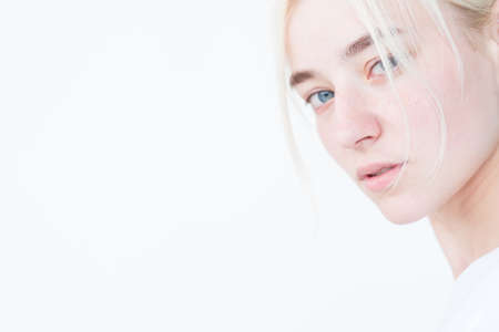 confident woman with piercing stern look portrait on white background.の写真素材